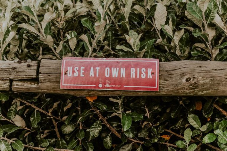 Risks - red and white wooden signage