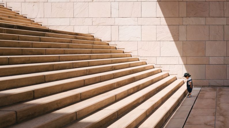 Steps - toddler's standing in front of beige concrete stair