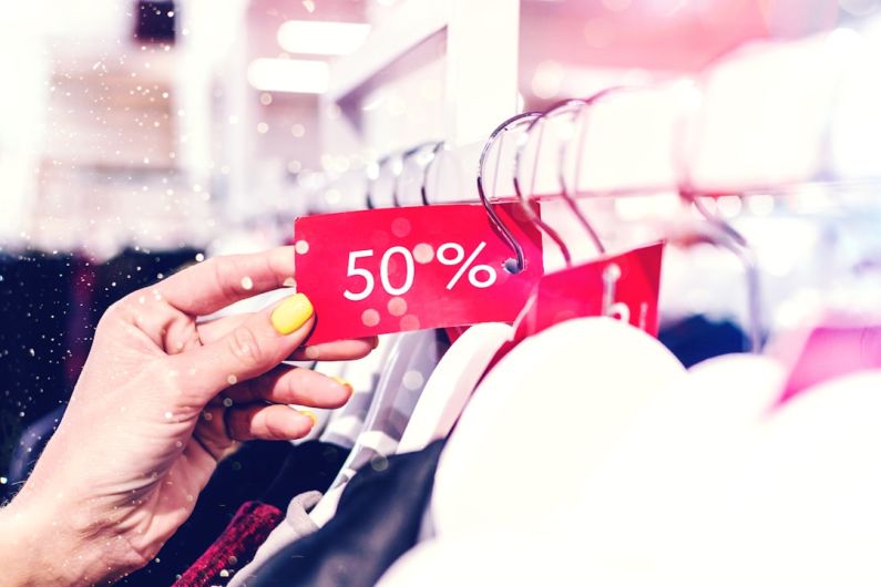 Price - person holding red and white love print gift wrapper