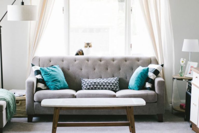 Home - brown and white wooden table beside sofa chair