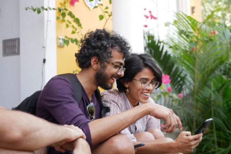 Millennials - man in black polo shirt sitting beside woman in purple shirt