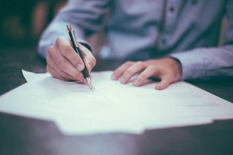 Policies - man writing on paper