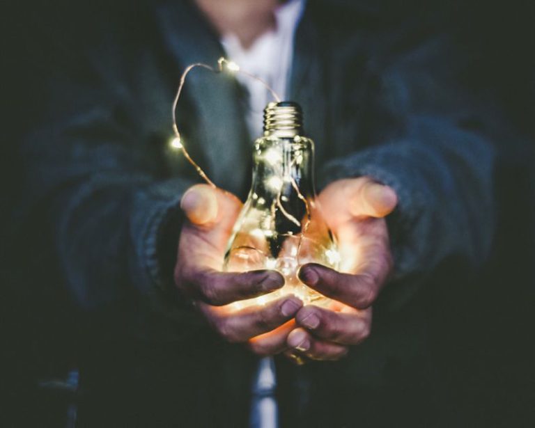 Value - man holding incandescent bulb