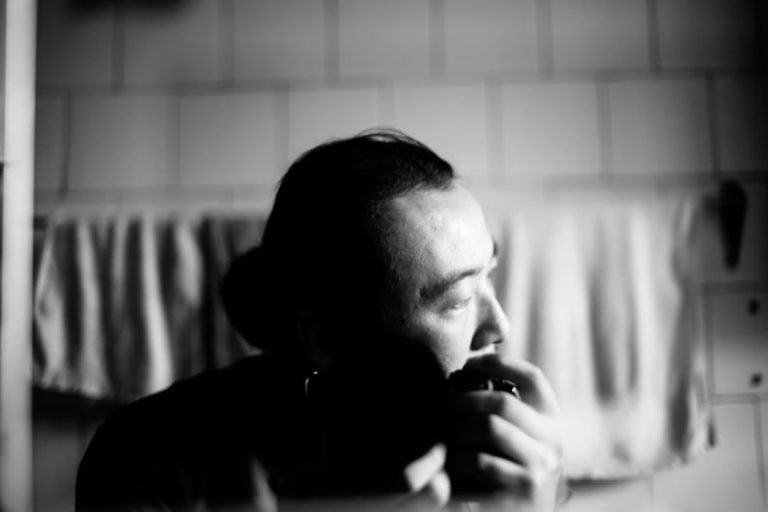 Implications - a black and white photo of a man brushing his teeth