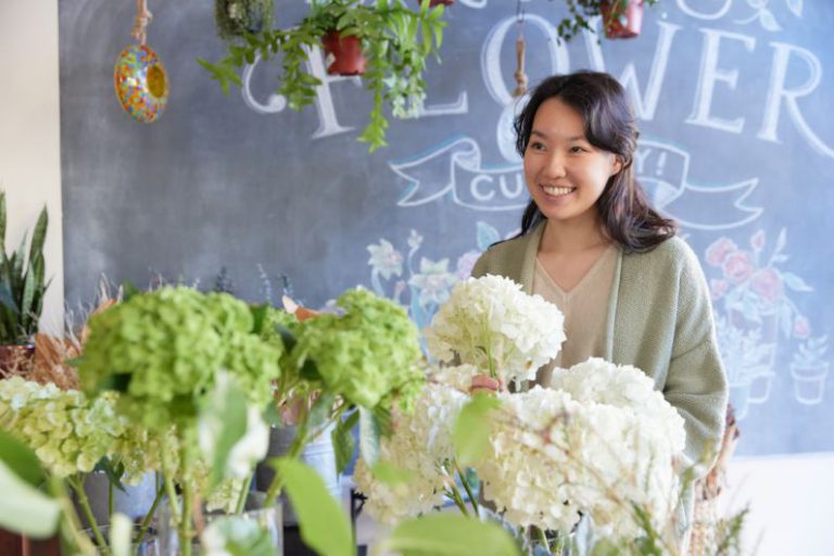 Neighborhood - woman smiling at flower shop