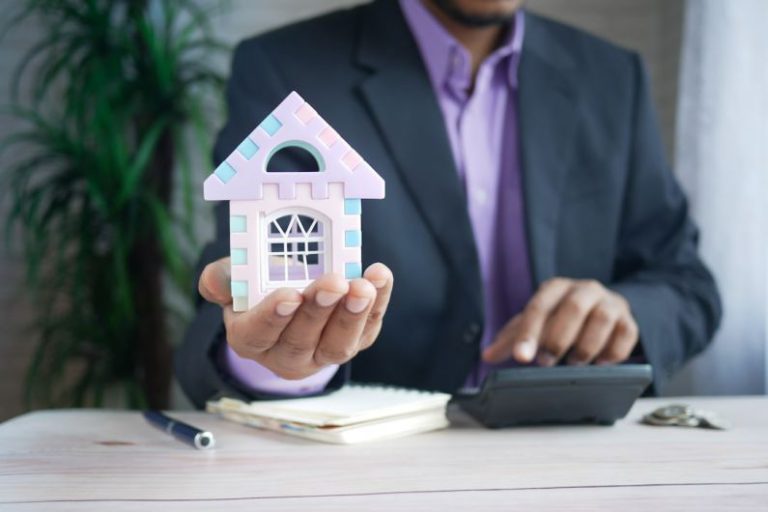 Mortgage - man in purple suit jacket using laptop computer