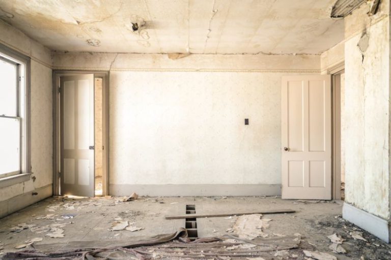 Renovations - gray concrete walls with broken floor