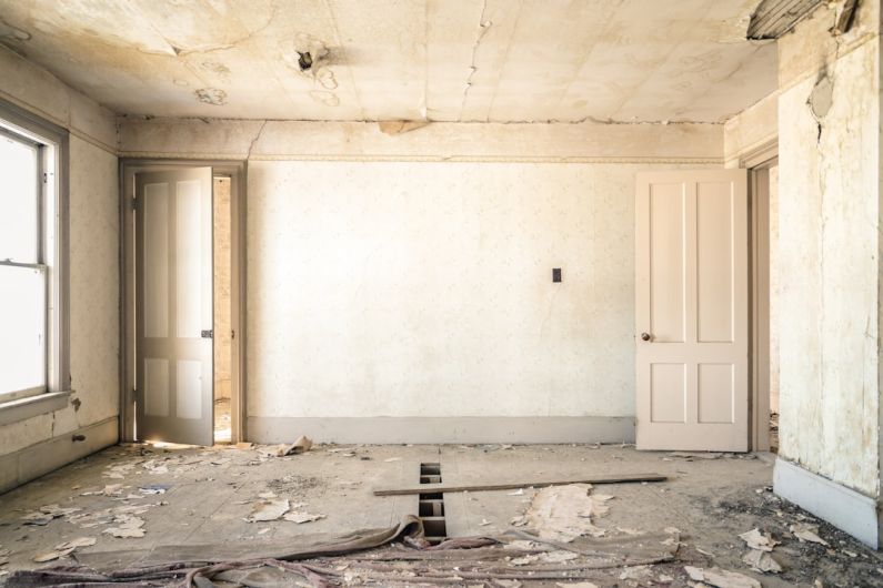 Renovations - gray concrete walls with broken floor