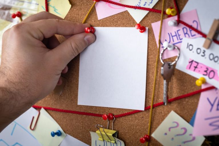 Inspector - shallow focus photo of white paper sheet mounted on cork board