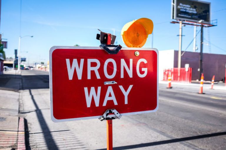 Issues - red Wrong Way signage on road