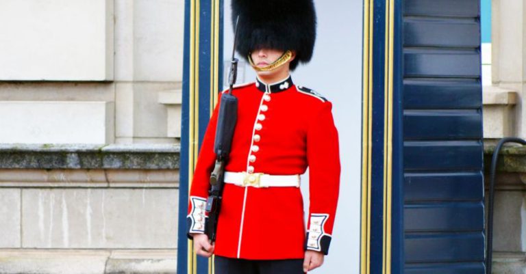 Contingency - Man in Red Tudor Uniform Holding a Firearm