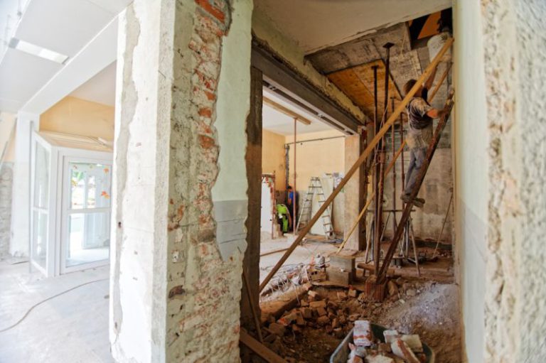 Renovation - man climbing on ladder inside room