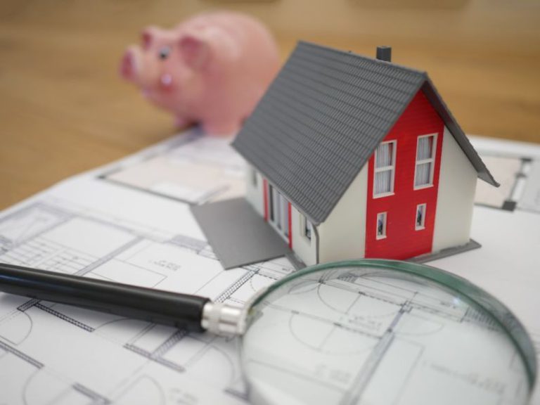 Financing - white and red wooden house beside grey framed magnifying glass