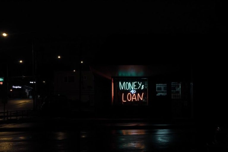 Loans - a neon sign is lit up in the dark